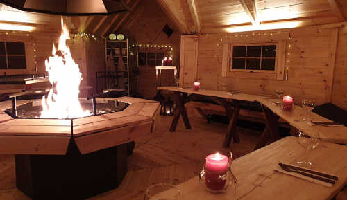 Interior hut with fire and Christmas lights.