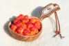 Wooden cup full of cloudberries.